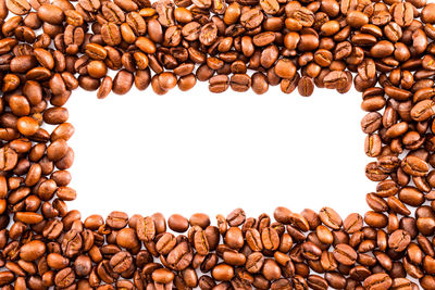Close-up of coffee beans against white background