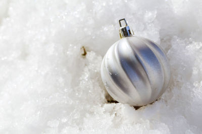 Close-up of christmas bauble on snow