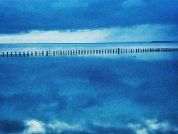 Scenic view of sea against cloudy sky