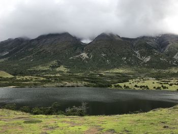 Scenic view of lake and mountains against sky