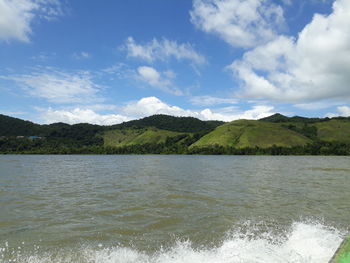 Scenic view of sea and mountains against sky