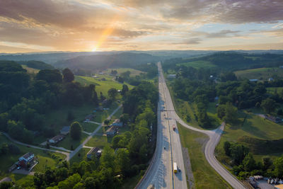 High angle view of road amidst landscape against sky during sunset