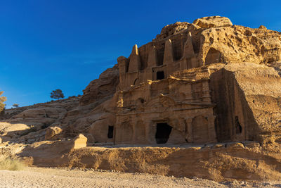 Rock formations in desert against clear blue sky