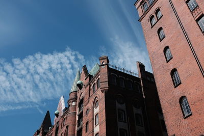 Low angle view of building against cloudy sky