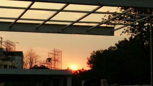 Low angle view of buildings against sky at sunset