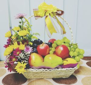 Various fruits in basket on table