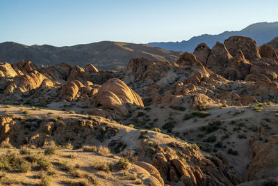 Scenic view of rocky terrain in desert mountains against sky
