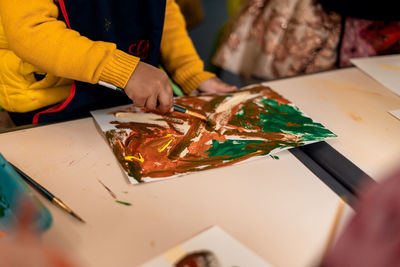 Close up shot of kids doing painting