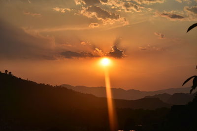 Scenic view of silhouette mountains against sky during sunset