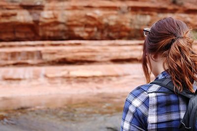 Rear view of woman standing outdoors