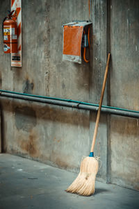 Close-up of broom hanging on wall