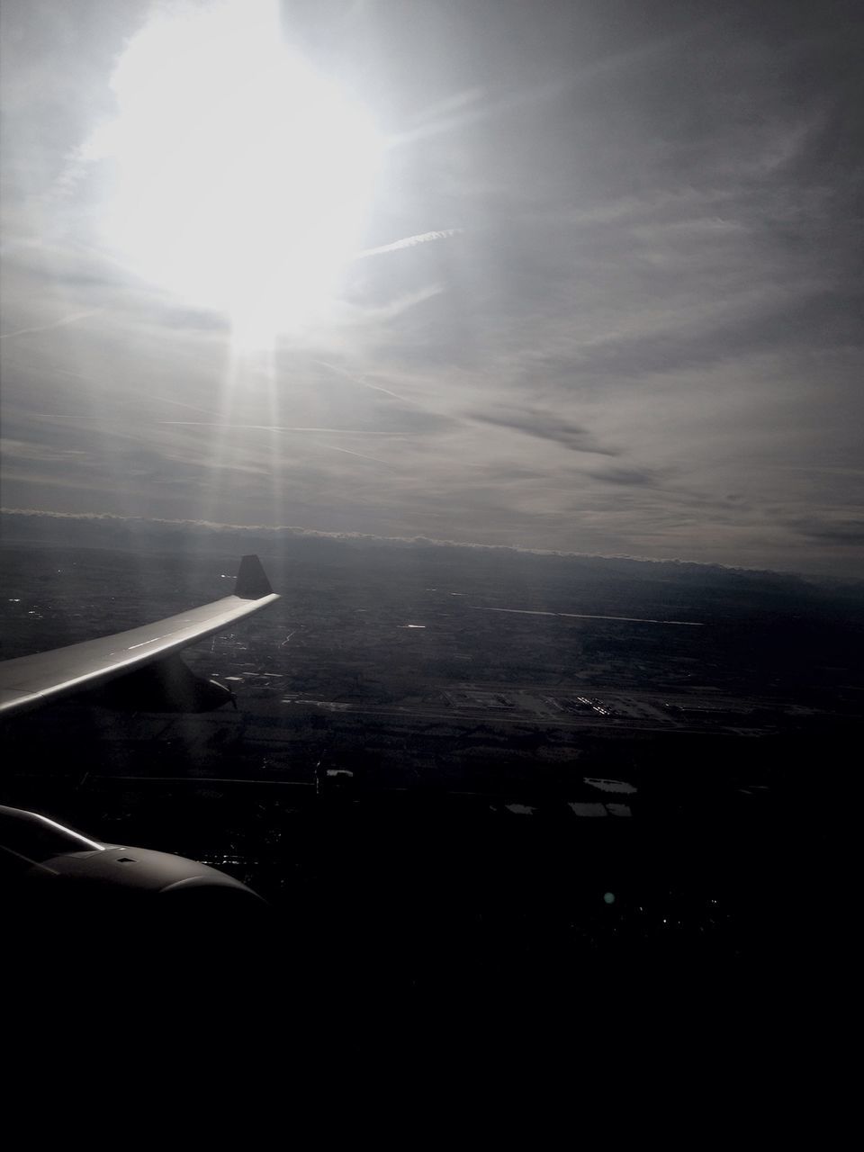 airplane, aircraft wing, air vehicle, flying, transportation, sky, aerial view, sea, mode of transport, scenics, sun, part of, beauty in nature, cropped, cloud - sky, nature, mid-air, sunlight, tranquil scene, tranquility