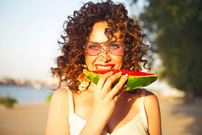 Portrait of woman eating watermelon
