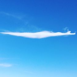 Low angle view of vapor trail in blue sky