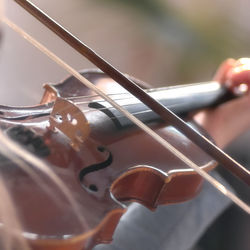 Close-up of person hand playing guitar