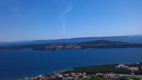 Scenic view of sea with houses in background