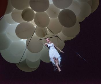 Digital composite image of woman with balloon balloons