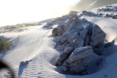 Scenic view of snow covered land against sky