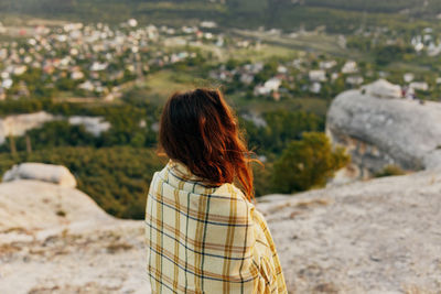 Rear view of woman standing outdoors