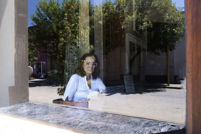 Portrait of a woman through a restaurant window