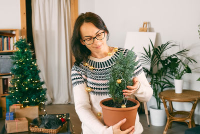 Portrait of smiling young woman sitting at home