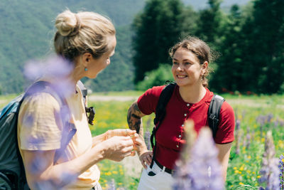 Two forties caucasian women hikers are communicating in the mountains.