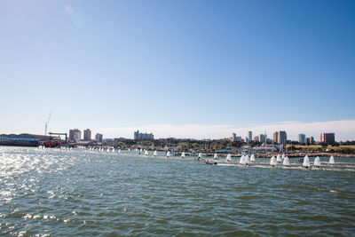 View of bay with buildings against clear sky