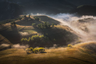 View from drone of incredible atmosphere with foggy hills at sunrise.