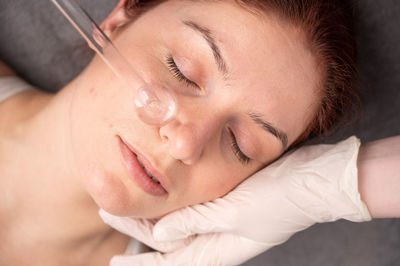 Close-up of young woman sleeping on bed at home