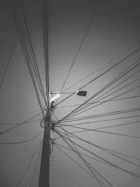 Low angle view of electricity pylon against clear sky