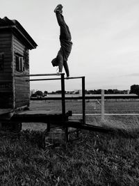 Full length of man balancing on railing at land