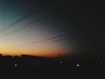 Silhouette of power lines at sunset