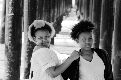 Portrait of sisters standing outdoors