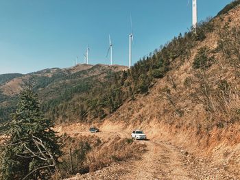 Car on road by land against sky