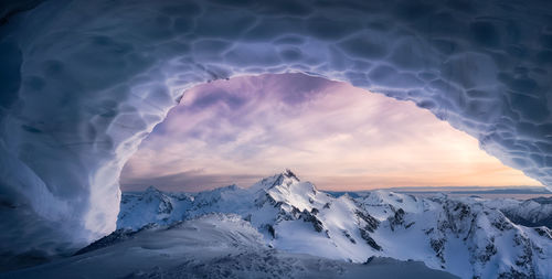 Scenic view of snowcapped mountains against sky during winter