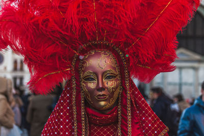 Close-up portrait of woman with red leaves