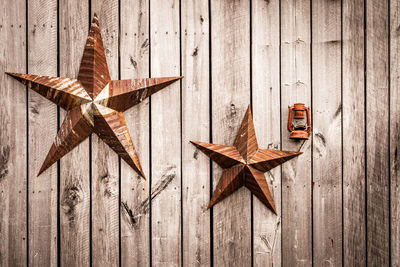 Close-up of star shape decorations of wooden wall