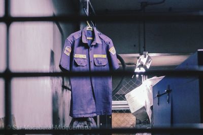 Man working on window of building