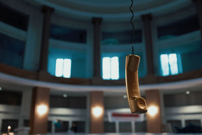 Close-up of telephone in illuminated room