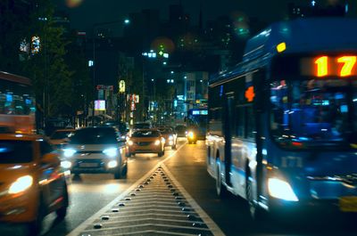 Vehicles on road in city at night