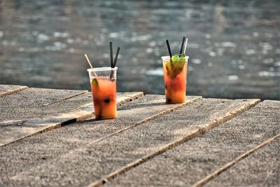 Close-up of drink on table against wall