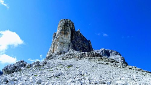 Low angle view of rock formations against blue sky