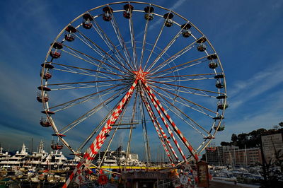 Low angle view of illuminated ferris wheel against sky