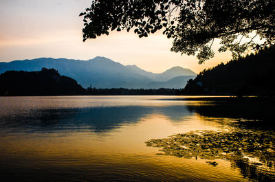 Scenic view of lake against sky during sunset