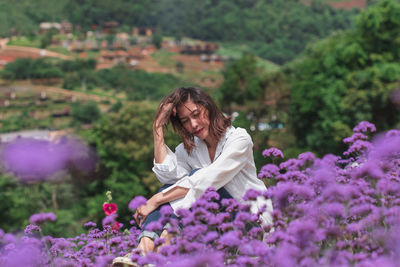 Young woman on purple flowering plants