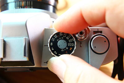 Close-up of hand adjusting camera