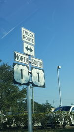 Low angle view of road sign against clear sky