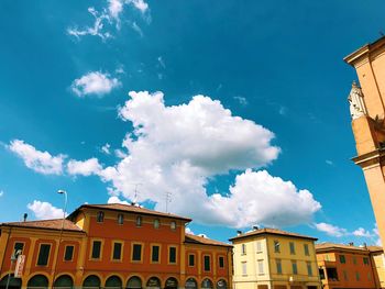 Low angle view of buildings against blue sky