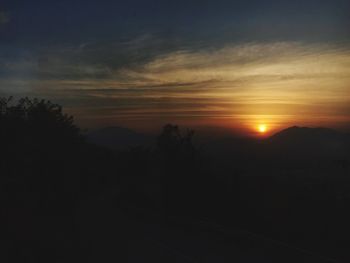 Scenic view of silhouette mountain against sky during sunset