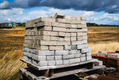 Stone stack on field against sky